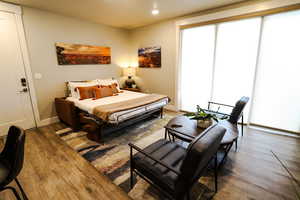 Bedroom with wood finished floors and recessed lighting