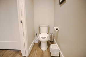 Bathroom with wood finished floors and toilet