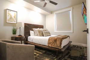 Bedroom featuring a ceiling fan and baseboards