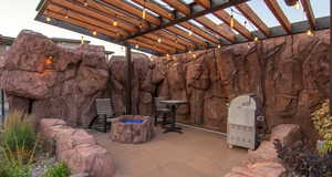 View of patio featuring a fire pit and a pergola