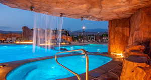 Community pool with a hot tub, a patio area, and a mountain view