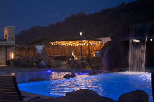 Pool at twilight featuring a patio area