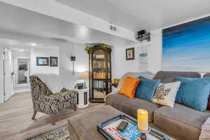 Living room with wood finished floors and a textured ceiling
