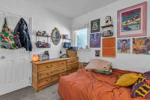 Bedroom featuring light colored carpet