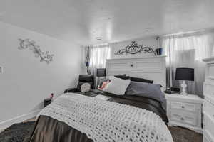 Bedroom featuring a textured ceiling and carpet