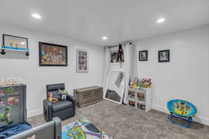 Recreation room with carpet floors and recessed lighting
