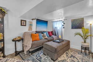 Living area with a textured ceiling and wood finished floors