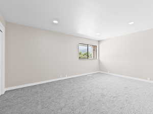 Spare room featuring carpet and recessed lighting