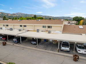 Covered parking lot featuring a mountain view