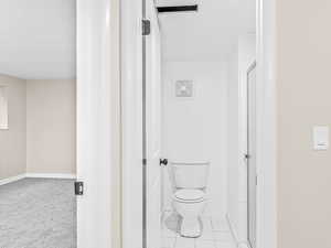 Bathroom featuring a shower stall and tile patterned floors