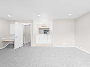 Unfurnished bedroom featuring light carpet and recessed lighting