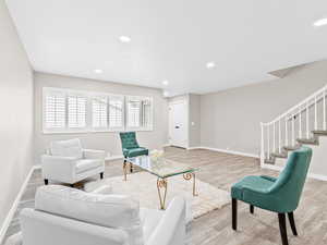 Living room featuring stairway, recessed lighting, and wood finished floors