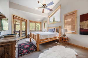 Bedroom 1 with mountain views, access to deck, vaulted ceiling, ceiling fan and AC