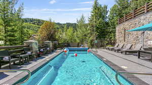 View of updated pool area featuring a sun deck and patio