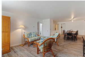 Living area featuring light wood finished floors and ceiling fan