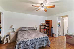 Bedroom with wood finished floors and ceiling fan
