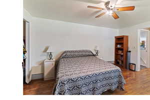 Bedroom featuring dark wood-style floors and ceiling fan