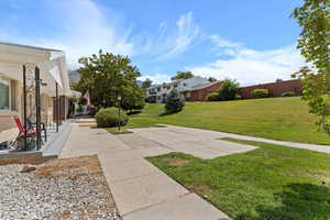 View of green lawn with a residential view