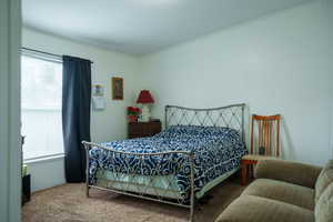 Carpeted bedroom with ornamental molding
