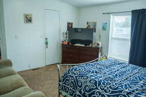 Carpeted bedroom featuring crown molding