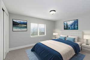 Carpeted bedroom with baseboards and a closet