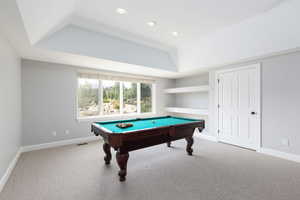 Recreation room featuring light colored carpet, billiards, a raised ceiling, and recessed lighting