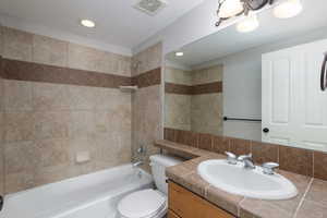 Full bathroom featuring washtub / shower combination, vanity, and recessed lighting