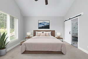 Bedroom with a barn door, carpet flooring, connected bathroom, high vaulted ceiling, and ceiling fan