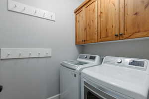 Laundry room with cabinet space and independent washer and dryer