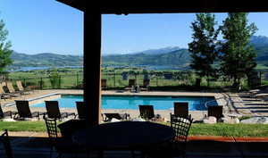 Community pool featuring a mountain view and a patio