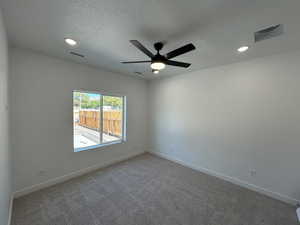 Carpeted spare room with recessed lighting, a ceiling fan, and a textured ceiling