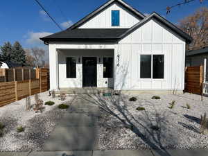View of front of property featuring a porch, board and batten siding, and a shingled roof