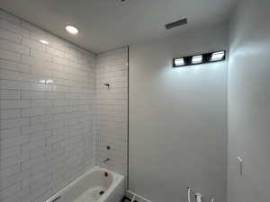 Hall Bathroom with shower / bathtub combination and recessed lighting