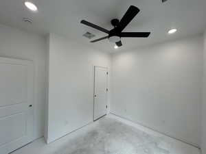 Bedroom 1 featuring concrete flooring, recessed lighting, and ceiling fan