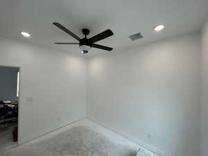 Bedroom 1 with unfinished concrete floors, recessed lighting, and ceiling fan