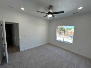 Unfurnished bedroom with carpet flooring, a ceiling fan, recessed lighting, and a textured ceiling