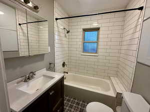 Bathroom featuring tub / shower combination and vanity