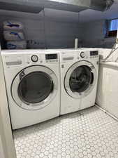 Washroom featuring washing machine and dryer