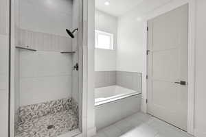 Bathroom featuring a bath and a shower stall