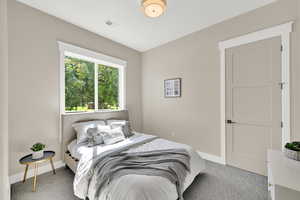 Carpeted bedroom with baseboards