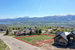 Aerial perspective of suburban area featuring mountains and property boundaries highlighted