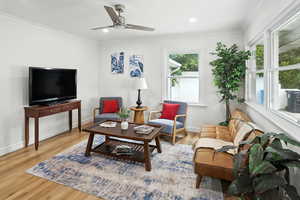 Living room featuring light wood finished floors, ornamental molding, recessed lighting, and ceiling fan