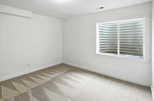 Spare room featuring carpet