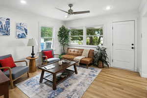 Living area featuring light wood finished floors, ornamental molding, a ceiling fan, and recessed lighting