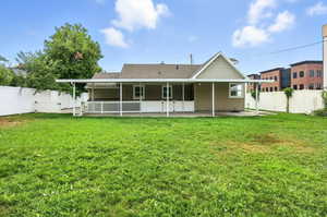 Back of house featuring a fenced backyard, a patio, a gate, and roof with shingles
