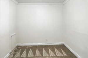 Unfurnished room featuring carpet flooring and ornamental molding