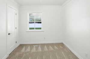 Empty room with carpet flooring and ornamental molding