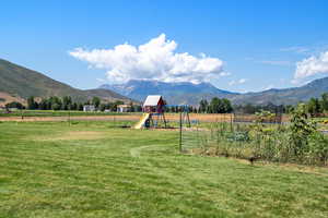 View of mountain backdrop featuring rural landscape