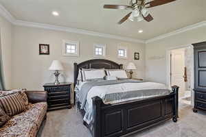 Bedroom featuring light colored carpet, multiple windows, crown molding, recessed lighting, and a ceiling fan