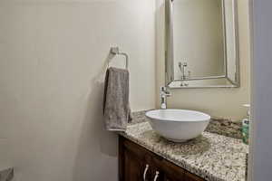 Bathroom featuring vanity and a textured wall